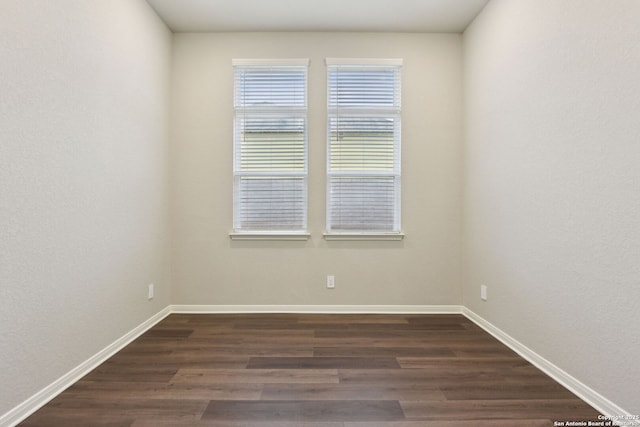 spare room with dark hardwood / wood-style floors