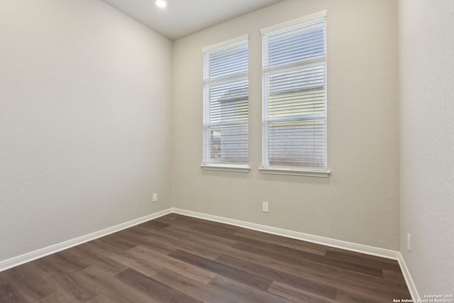 unfurnished room featuring dark hardwood / wood-style flooring