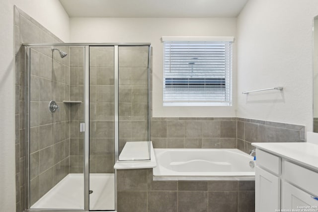 bathroom featuring vanity and separate shower and tub