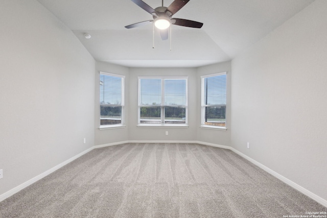 empty room with lofted ceiling, ceiling fan, and carpet