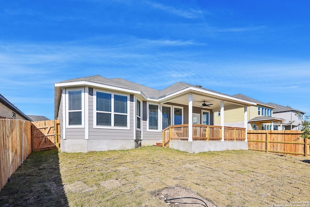 back of house with a lawn, ceiling fan, and a porch