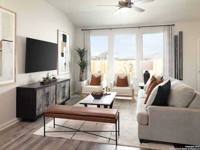 living room with vaulted ceiling, ceiling fan, and light hardwood / wood-style floors