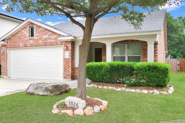 ranch-style house featuring a garage and a front yard