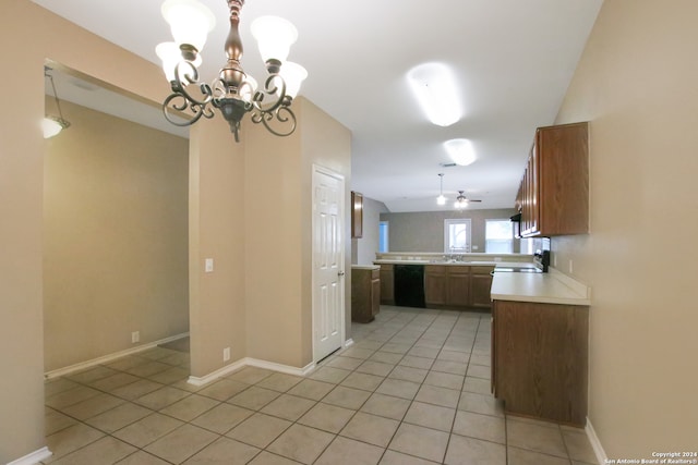 kitchen with ceiling fan with notable chandelier, kitchen peninsula, and hanging light fixtures