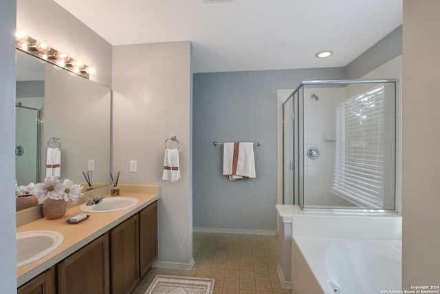 bathroom with vanity and shower with separate bathtub