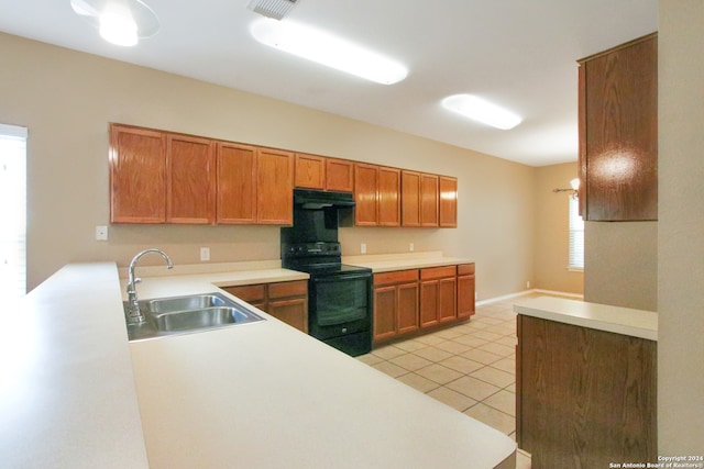 kitchen with exhaust hood, sink, black / electric stove, light tile patterned flooring, and kitchen peninsula