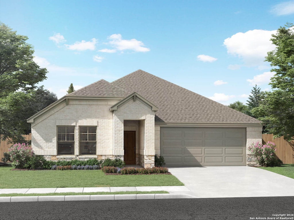 view of front facade with a garage and a front lawn