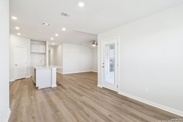 interior space with ceiling fan, light wood-type flooring, and sink