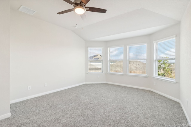 spare room with ceiling fan, carpet floors, and vaulted ceiling