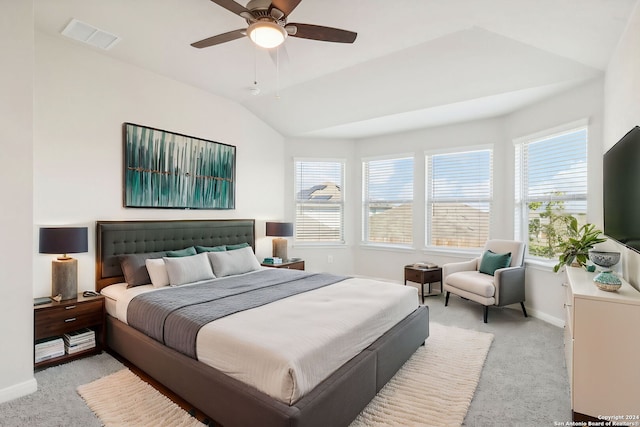 bedroom with multiple windows, ceiling fan, light carpet, and lofted ceiling