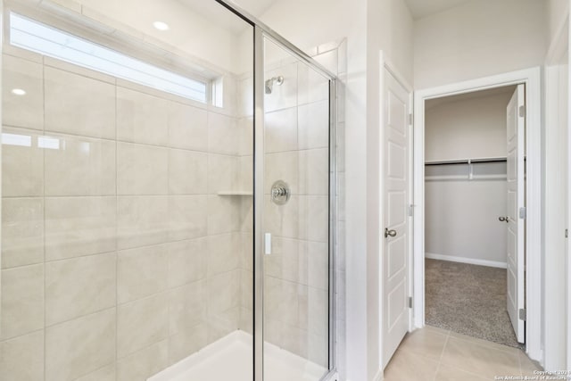 bathroom featuring tile patterned floors and an enclosed shower