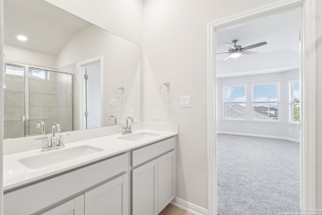 bathroom with ceiling fan, vanity, an enclosed shower, and lofted ceiling