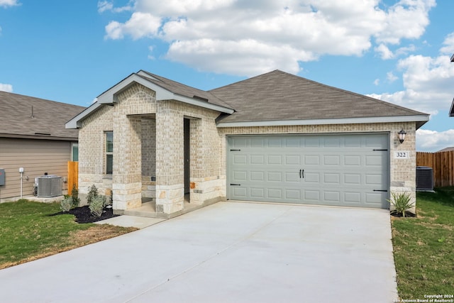 single story home with a garage and central AC unit