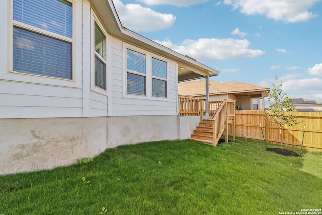 exterior space featuring a deck and a lawn