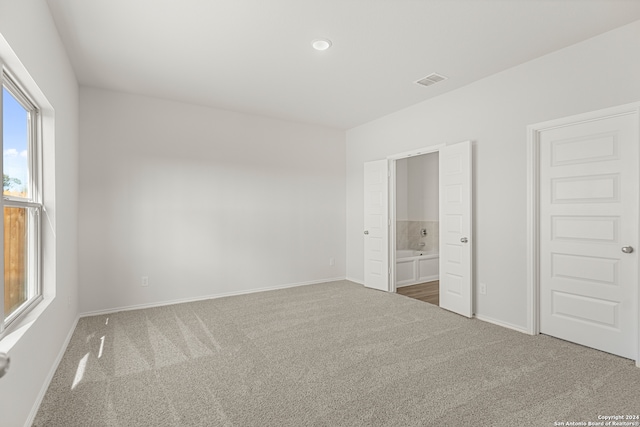 unfurnished bedroom featuring carpet and ensuite bathroom