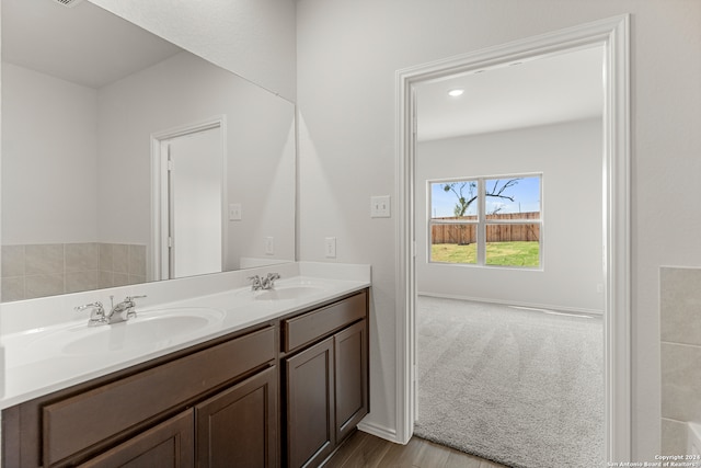 bathroom with hardwood / wood-style floors and vanity