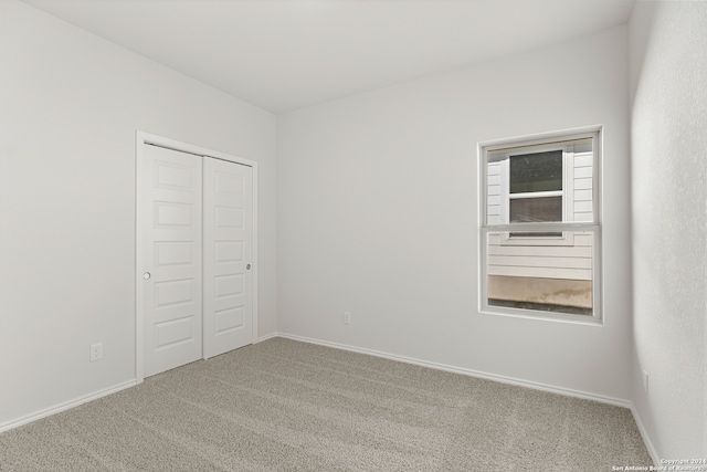 unfurnished bedroom with carpet floors and a closet