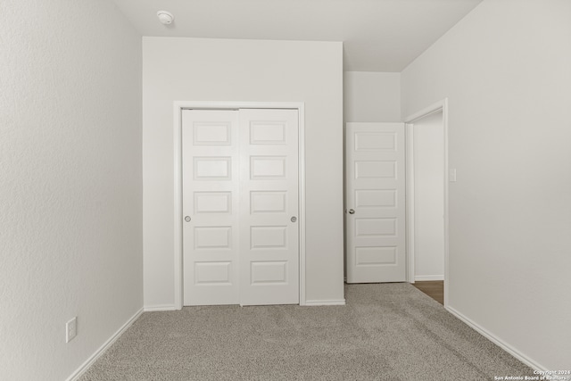 unfurnished bedroom featuring a closet and carpet