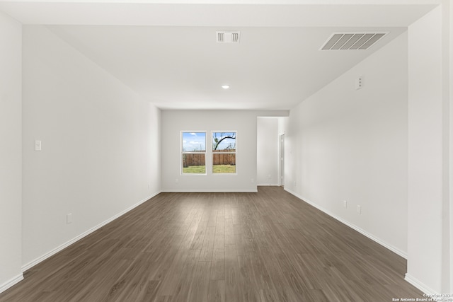 empty room with dark hardwood / wood-style flooring