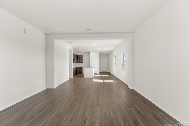 unfurnished living room featuring dark hardwood / wood-style floors