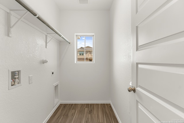 washroom with hardwood / wood-style flooring, electric dryer hookup, and hookup for a washing machine