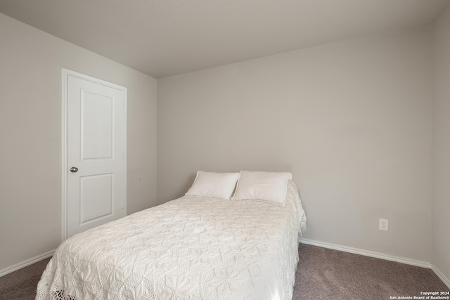 bedroom with dark colored carpet