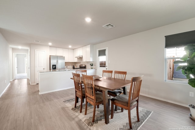 dining area with light hardwood / wood-style floors