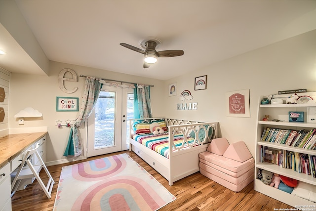 bedroom featuring access to exterior, light wood-type flooring, and ceiling fan