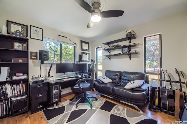 home office featuring ceiling fan and light hardwood / wood-style flooring