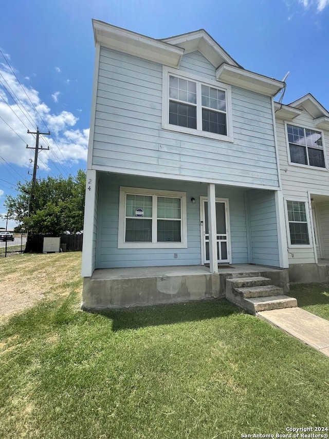 view of front facade with a porch and a front lawn