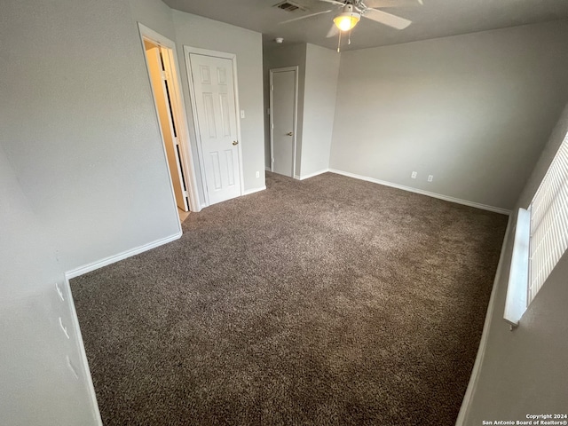 unfurnished room featuring ceiling fan and carpet