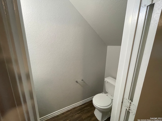 bathroom with hardwood / wood-style flooring and toilet