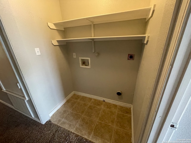 washroom featuring electric dryer hookup, gas dryer hookup, hookup for a washing machine, and dark tile patterned floors