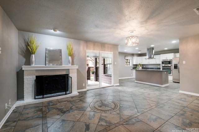 4212 Medical Dr Unit 902, San Antonio, TX 78229 - kitchen with stainless steel appliances, stone tile floors, baseboards, island exhaust hood, and white cabinets