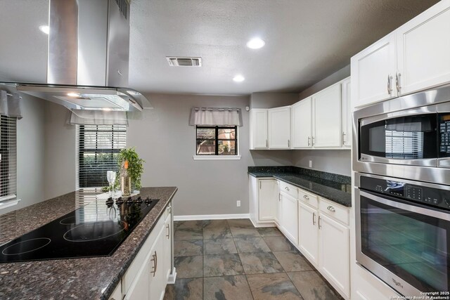 4212 Medical Dr Unit 902, San Antonio, TX 78229 - living area with a ceiling fan, a textured ceiling, baseboards, and a fireplace