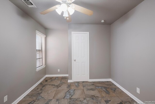 4212 Medical Dr Unit 902, San Antonio, TX 78229 - unfurnished room with baseboards, stone finish floors, a ceiling fan, and a smoke detector