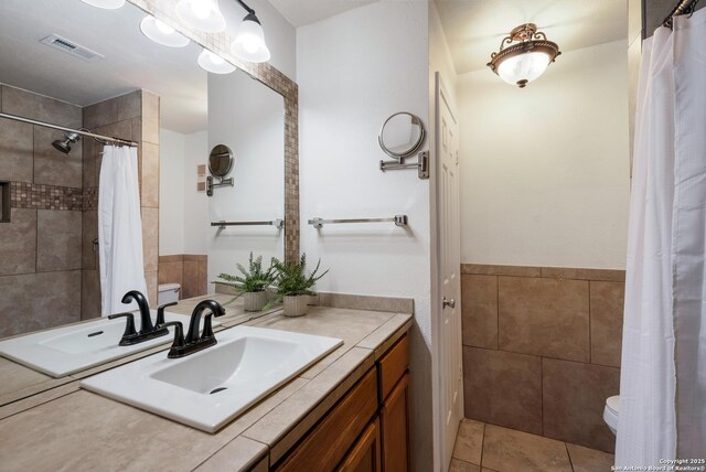 4212 Medical Dr Unit 902, San Antonio, TX 78229 - full bathroom with toilet, vanity, tile walls, tiled shower, and tile patterned flooring