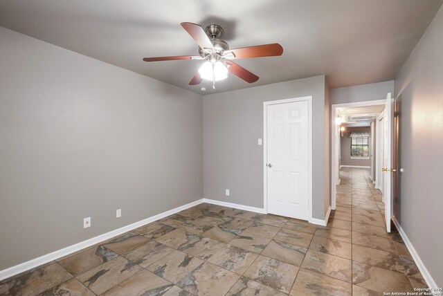 4212 Medical Dr Unit 902, San Antonio, TX 78229 - unfurnished bedroom featuring baseboards, a ceiling fan, and stone finish flooring