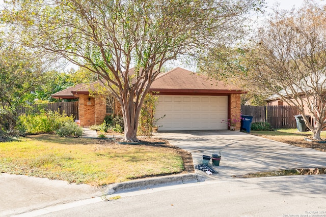 view of front of home with a garage and a front lawn