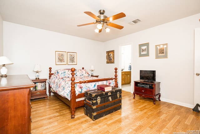 bedroom with ceiling fan, light wood-type flooring, and ensuite bathroom