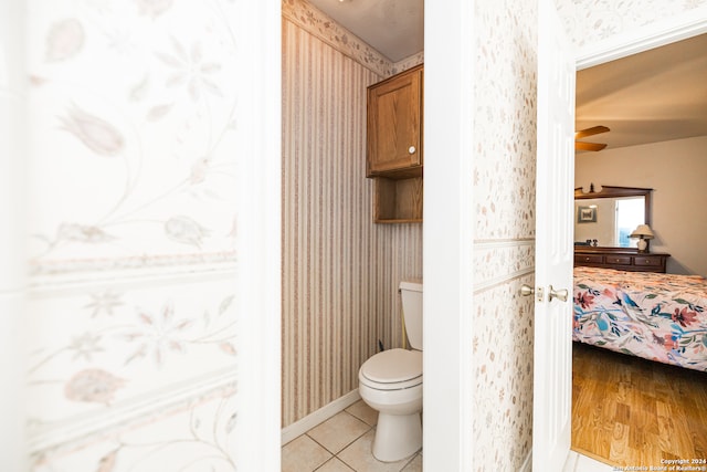 bathroom featuring hardwood / wood-style floors, ceiling fan, and toilet