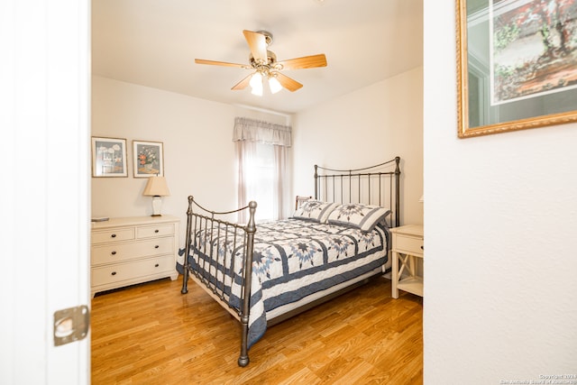 bedroom with ceiling fan and light wood-type flooring