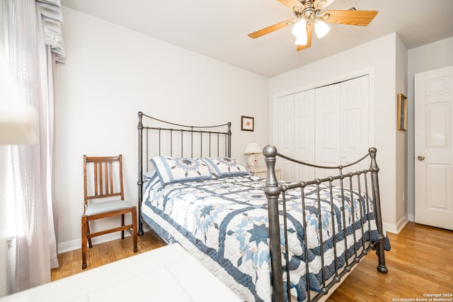 bedroom with wood-type flooring, a closet, and ceiling fan