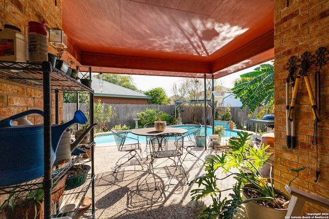 view of patio with a fenced in pool