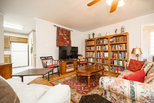 living room featuring light hardwood / wood-style flooring, ceiling fan, and ornamental molding