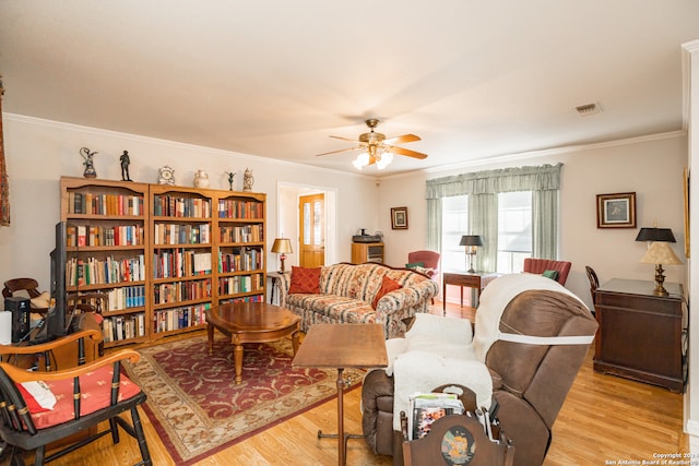 living room featuring light hardwood / wood-style floors, ceiling fan, and crown molding