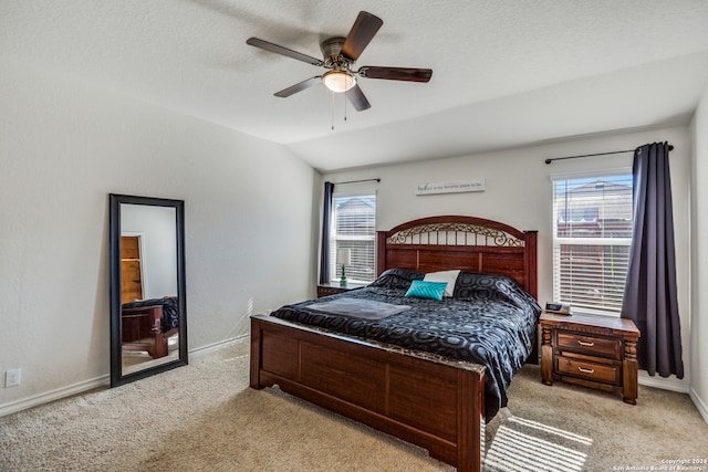 bedroom featuring a textured ceiling, ceiling fan, light carpet, and vaulted ceiling