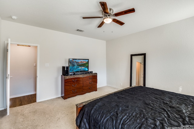 bedroom featuring ceiling fan and light carpet