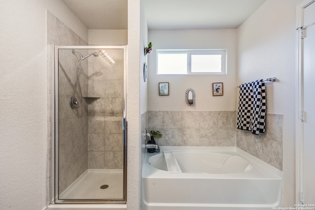 bathroom with shower with separate bathtub