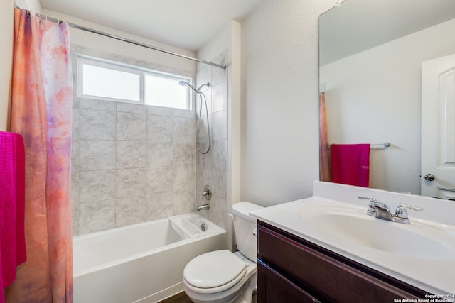 full bathroom with vanity, shower / bath combination with curtain, and toilet